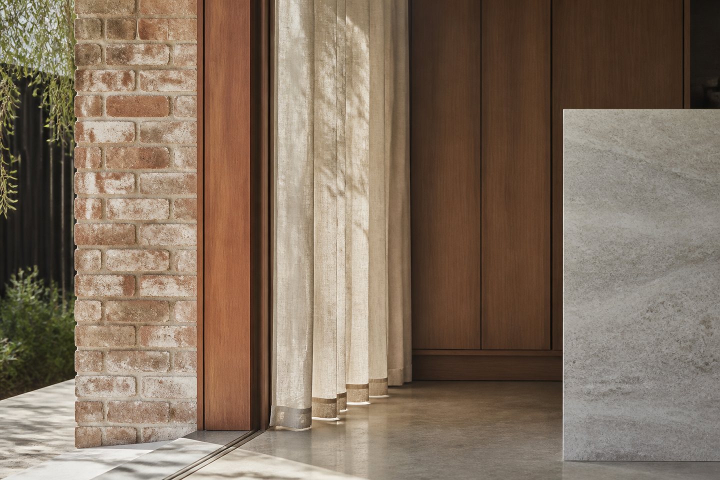Brick, timber, linen and stone meeting at an interior threshold